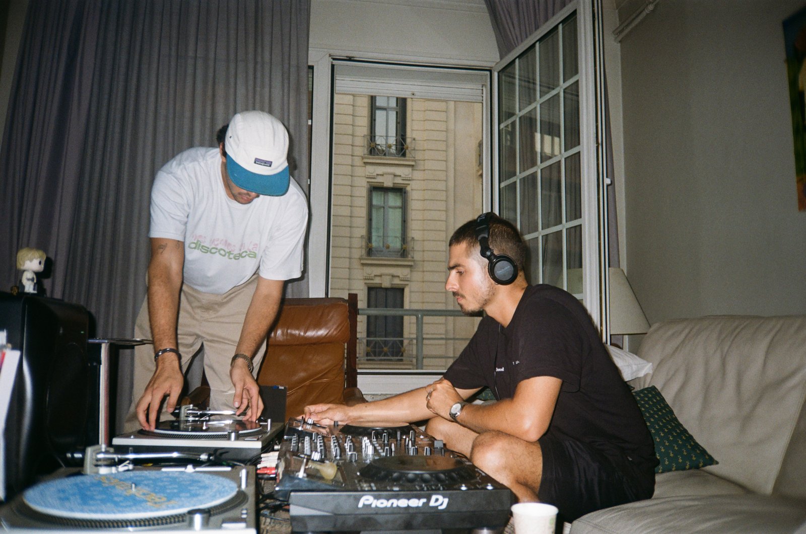 Two of The Jabba Records crew DJing with turntables in a Barcelona living room